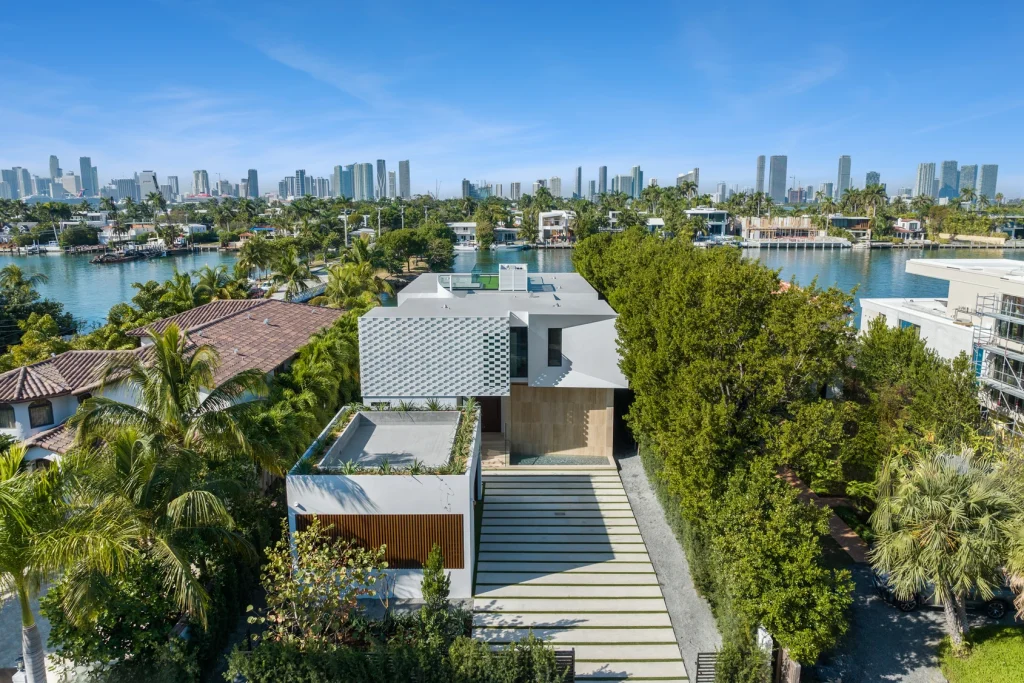 Modern driveway leading to a contemporary waterfront property for sale.