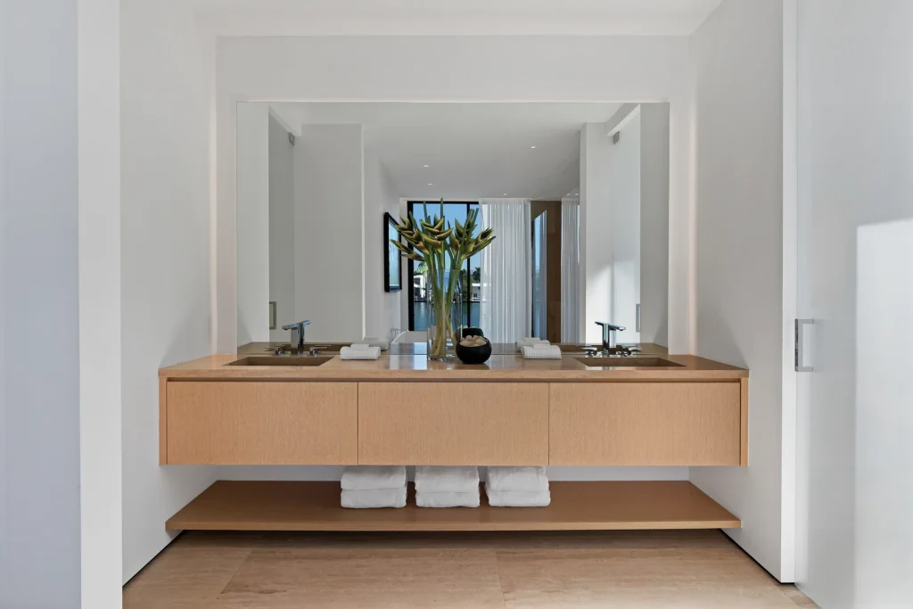 Elegant bathroom with modern wooden vanity in a Miami waterfront property for sale.