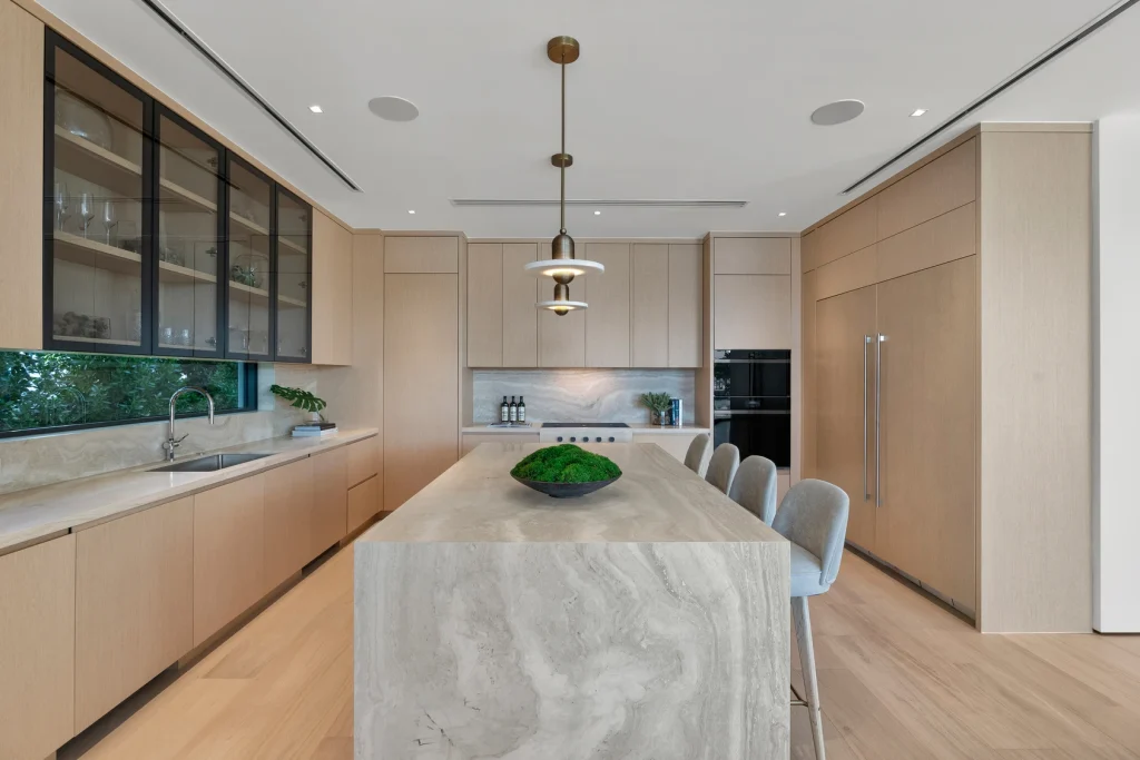 Modern kitchen design featuring sleek appliances and marble countertops in a Miami waterfront property for sale.
